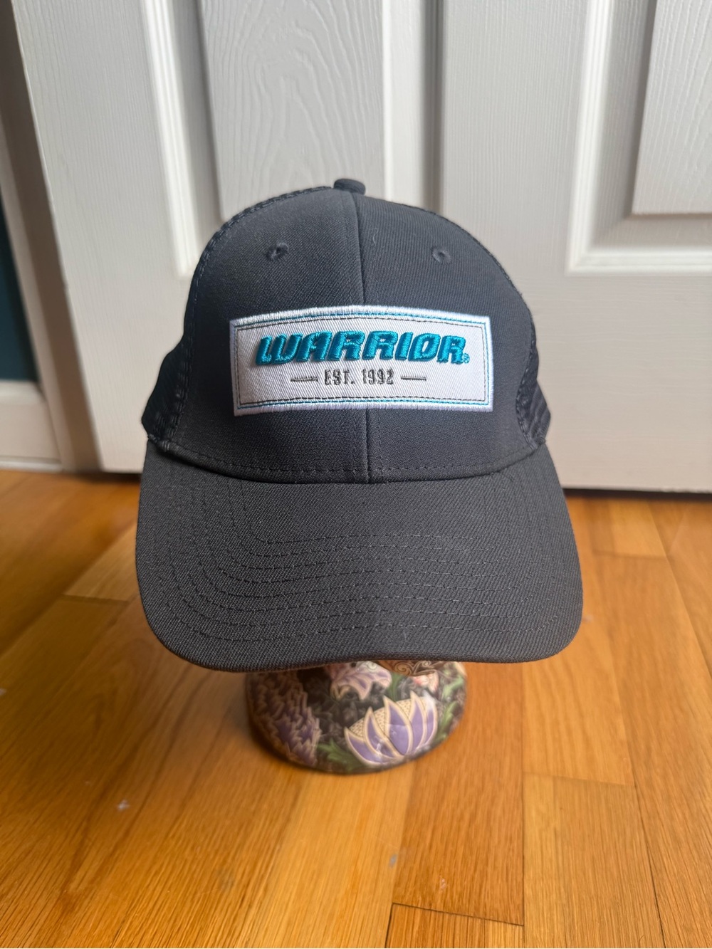 Warrior Patch Trucker Hat in Charcoal with Teal Logo